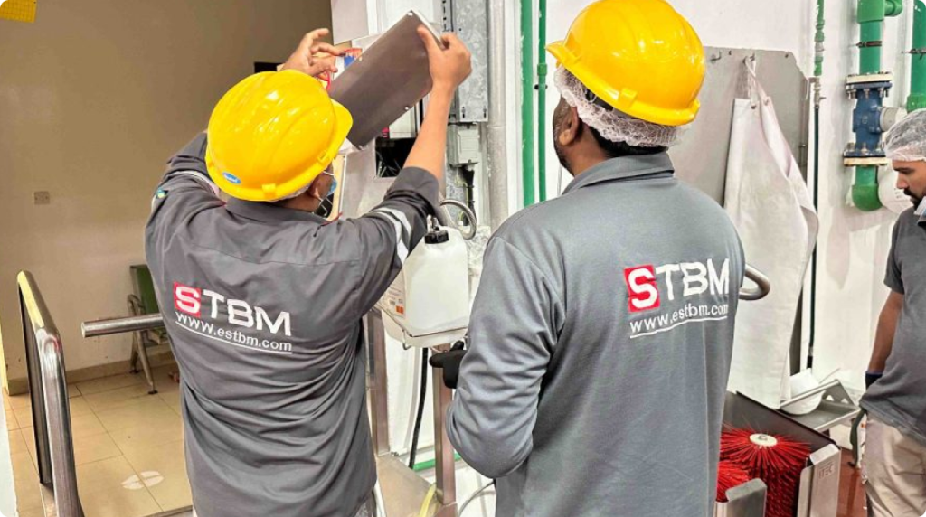 STBM engineers servicing electromechanical equipment at a food facility